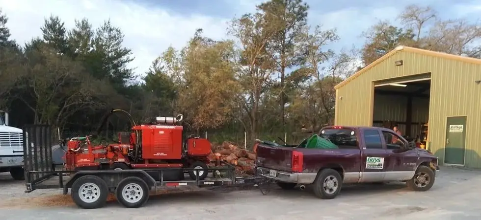 The Rite Guys Tree Service wood chipper and pickup truck parked on a job site